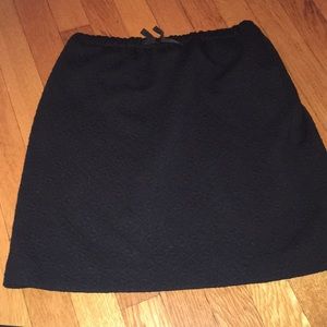 Black textured skirt.